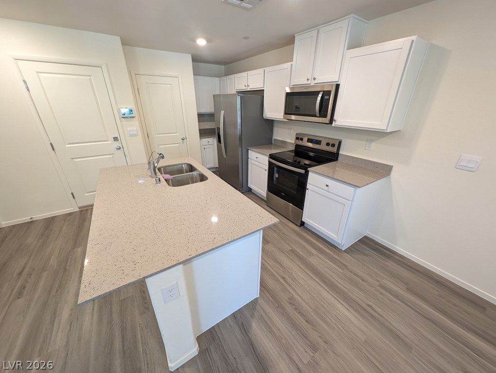 4820 Orchid Rdg Avenue Las Vegas, NV 89141 - Photo 9 of 27 A well-appointed kitchen showcasing an island with a double sink and ample counter space.
