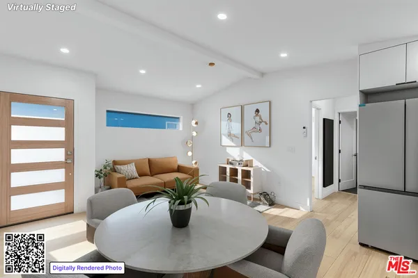 a living room with furniture kitchen view and a window