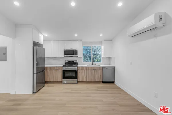 a kitchen with a white stove top oven and refrigerator