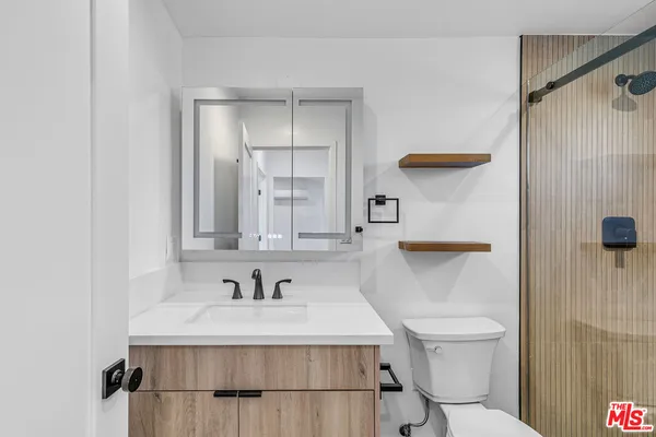 a bathroom with a sink toilet and shower