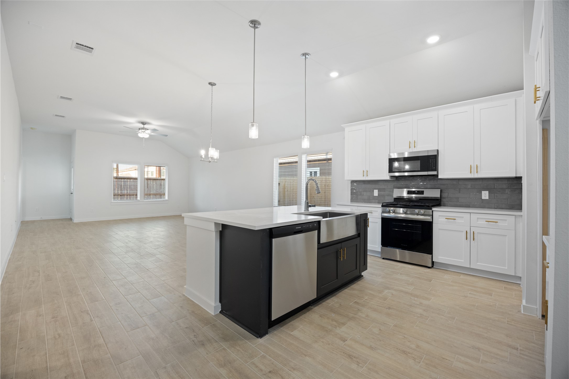 1123 Santee Court Rosharon, TX 77583 - Photo 12 of 30 a kitchen with stainless steel appliances kitchen island granite countertop a stove a sink and a microwave