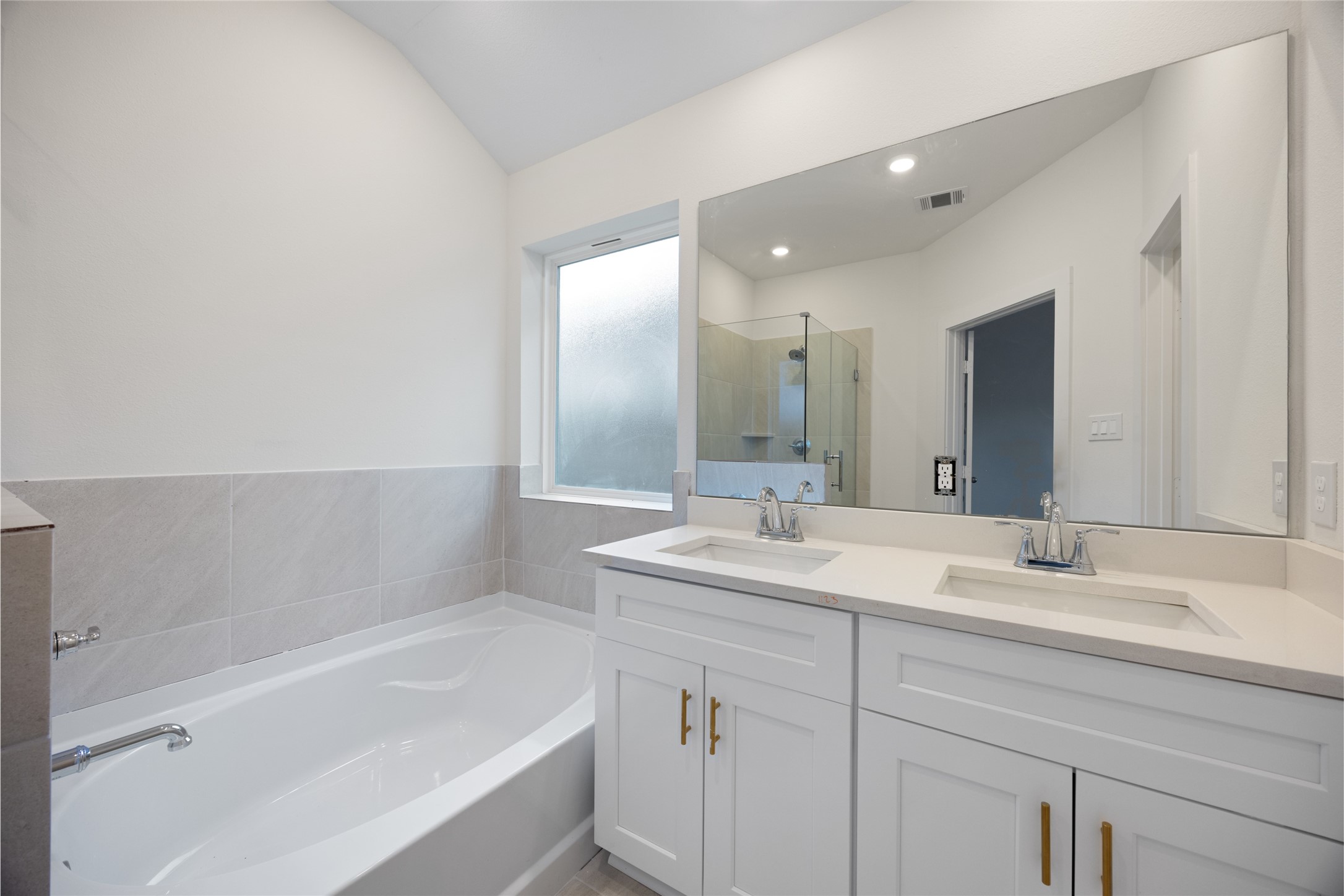 1123 Santee Court Rosharon, TX 77583 - Photo 21 of 30 a bathroom with a bathtub sink double vanity and mirror