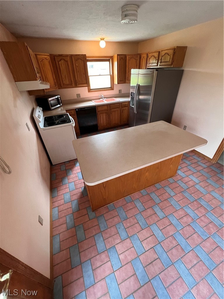 5435 Columbia Road Medina, OH 44256 - Photo 6 of 30 Kitchen with dishwashing machine, fridge, countertops light, light tile floors, and sink