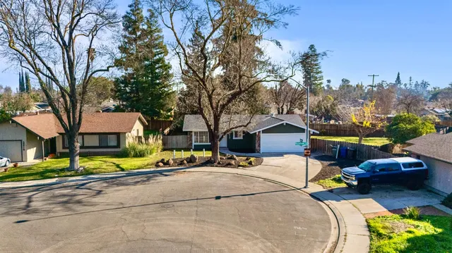 a view of house with outdoor space and parking
