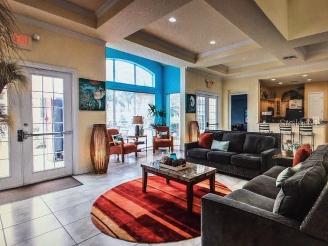 5252 Cane Island Loop, Unit 301 Kissimmee, FL 34746 - Photo 28 of 30 a living room with furniture wooden floor and a large window