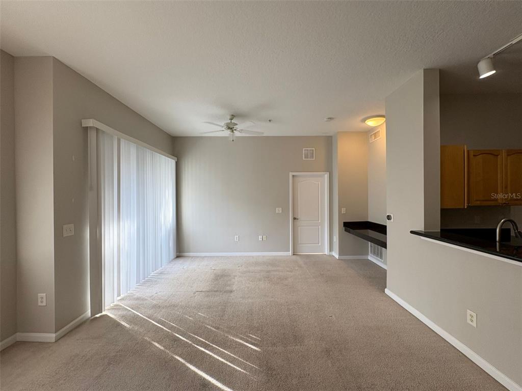 5252 Cane Island Loop, Unit 301 Kissimmee, FL 34746 - Photo 5 of 30 a view of a kitchen with a sink and cabinet area