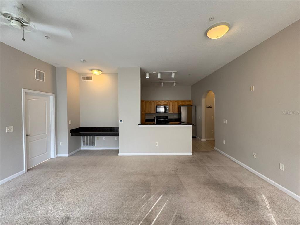 5252 Cane Island Loop, Unit 301 Kissimmee, FL 34746 - Photo 6 of 30 a view of a kitchen with a sink and a refrigerator