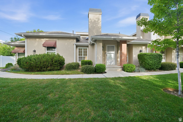 6969 South 855 East Midvale, UT 84047 - Photo 1 of 55 Stucco exterior featuring multiple chimneys and mature landscaping