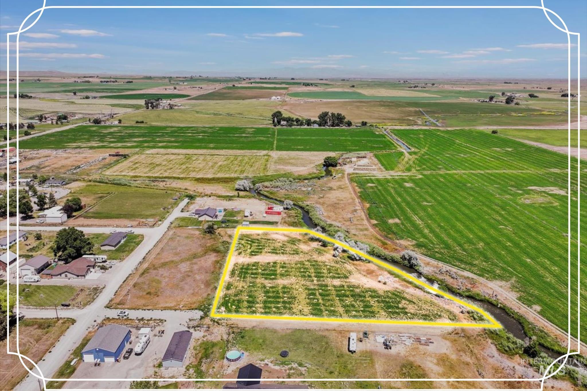 Aerial view of sparsely populated area featuring property parcel outlined