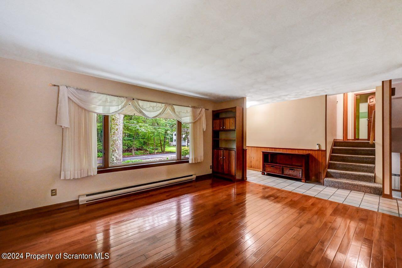 749 Elkview Drive Forest City, PA 18421 - Photo 11 of 73 a view of an empty room with wooden floor and a window