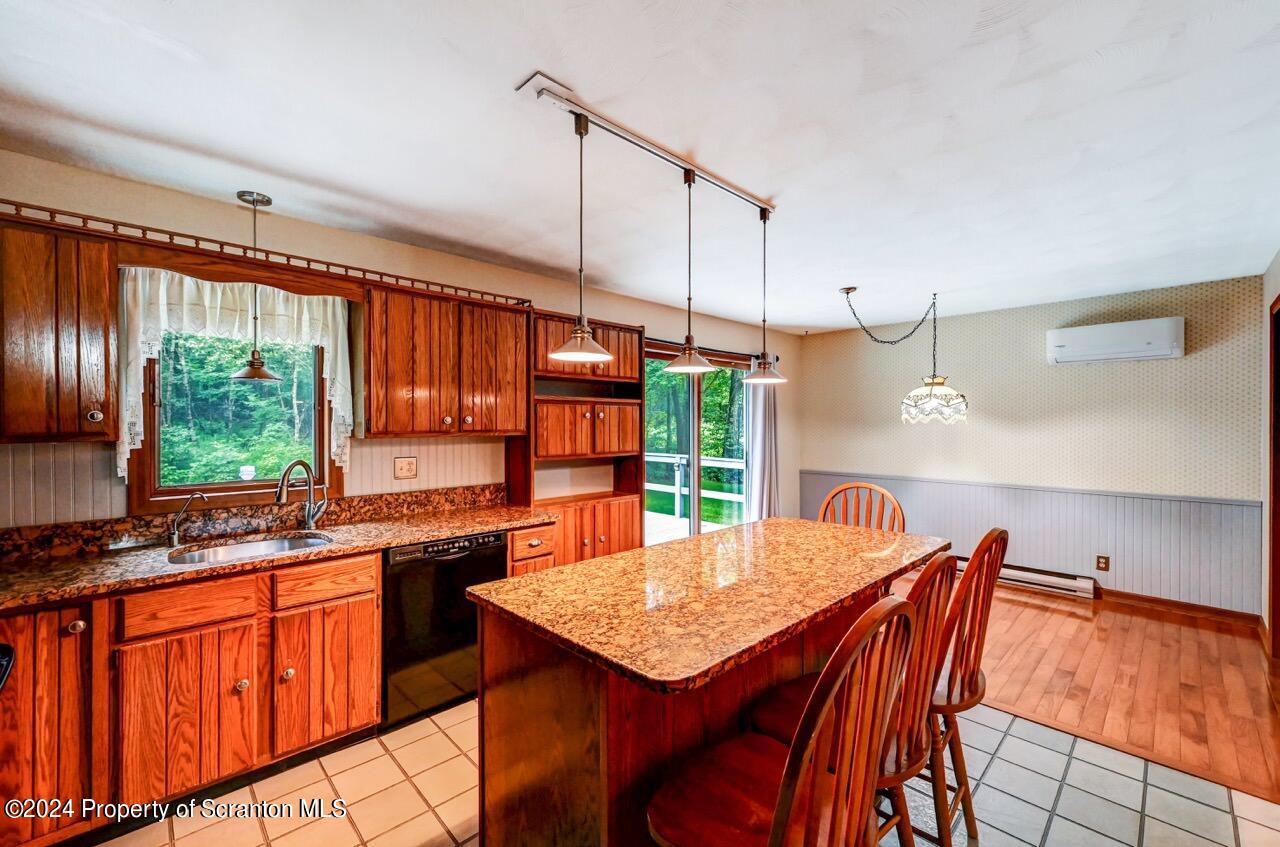 749 Elkview Drive Forest City, PA 18421 - Photo 12 of 73 a kitchen with stainless steel appliances granite countertop a stove a sink dishwasher and a refrigerator with wooden floor