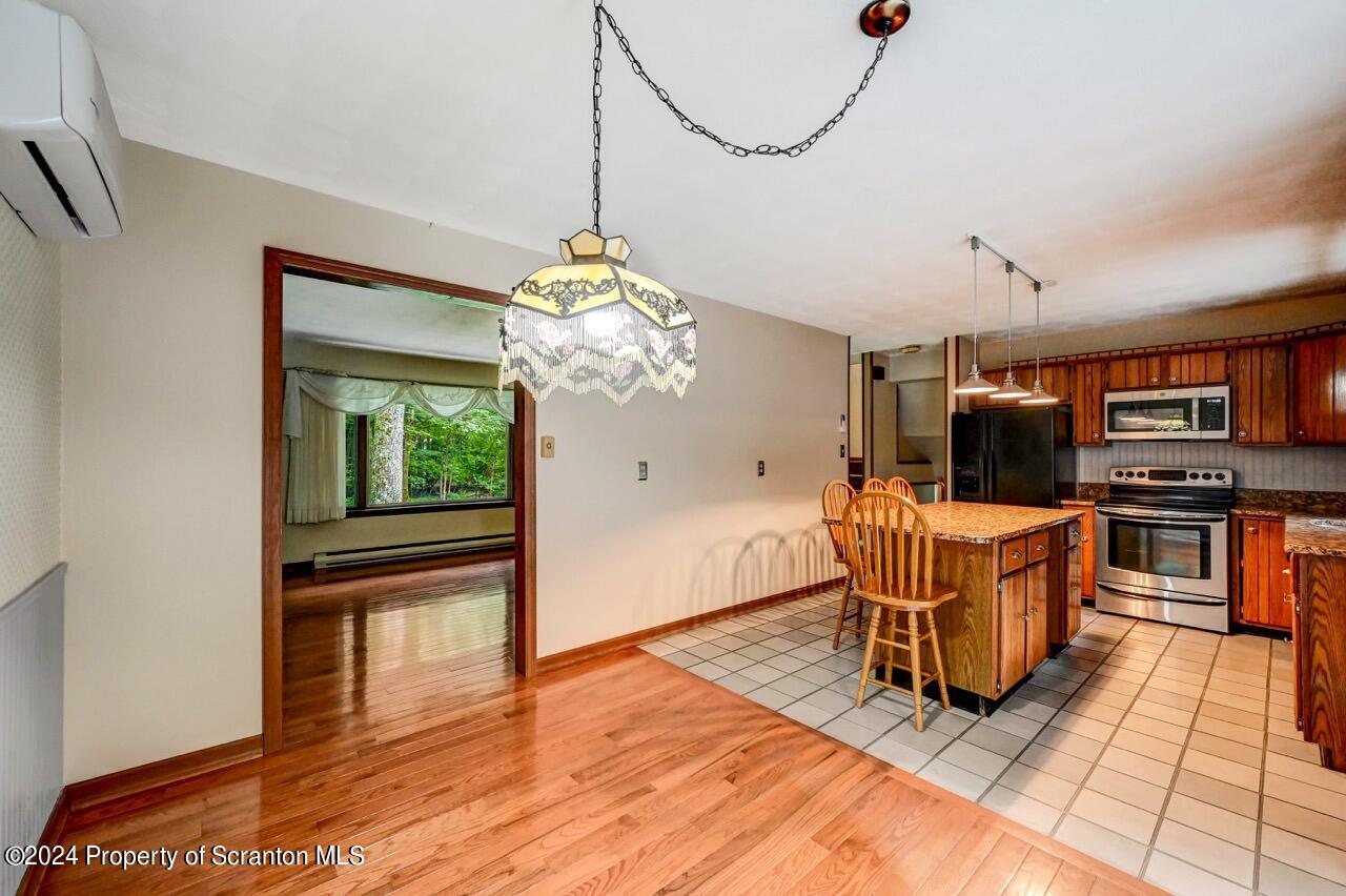 749 Elkview Drive Forest City, PA 18421 - Photo 15 of 73 a view of a dining room with furniture a chandelier and wooden floor