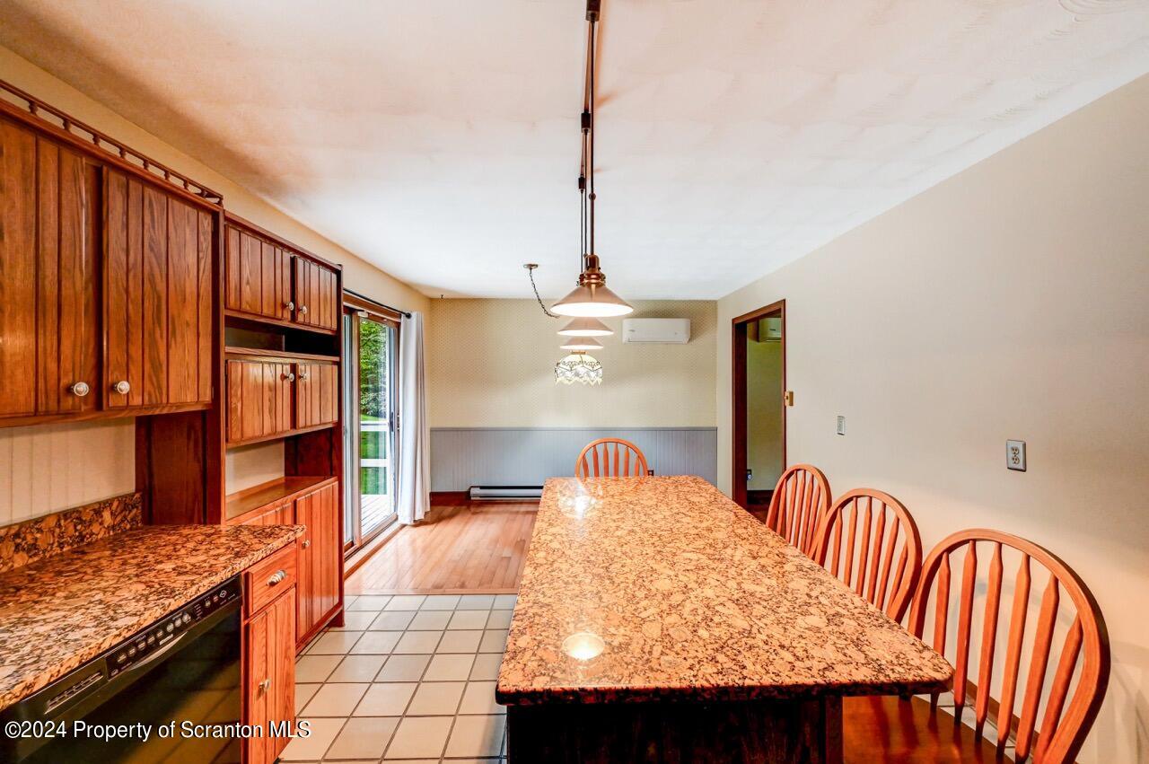 749 Elkview Drive Forest City, PA 18421 - Photo 20 of 73 a bedroom with a bed a dresser and potted plants