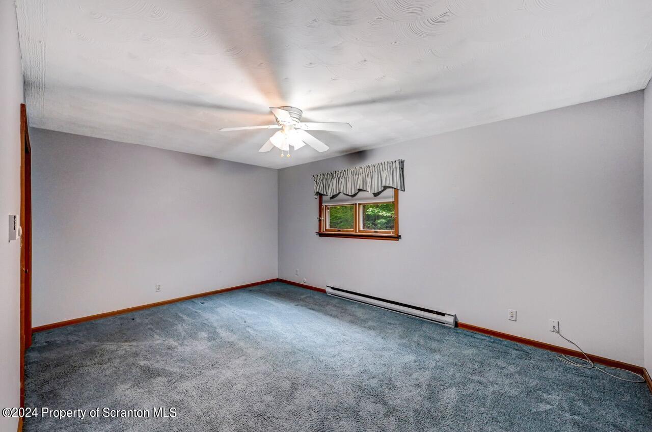 749 Elkview Drive Forest City, PA 18421 - Photo 23 of 73 an empty room with a chandelier fan and windows