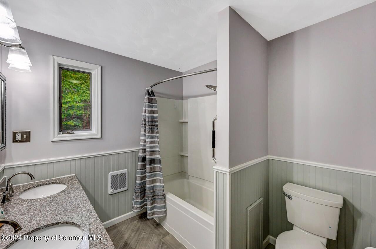749 Elkview Drive Forest City, PA 18421 - Photo 27 of 73 a bathroom with a granite countertop sink toilet and shower