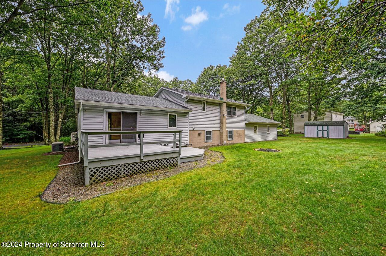 749 Elkview Drive Forest City, PA 18421 - Photo 4 of 73 a view of a white house in front of a big yard with large trees
