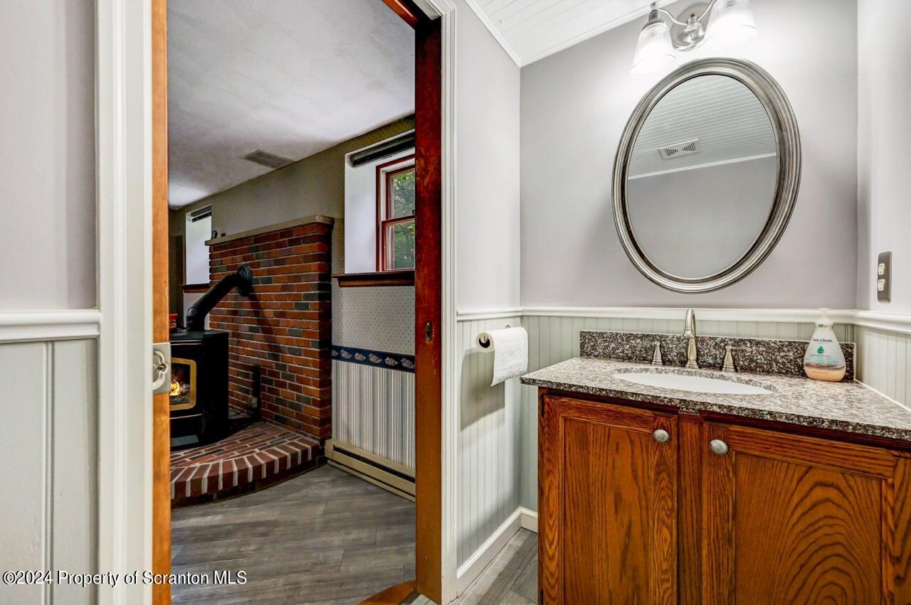 749 Elkview Drive Forest City, PA 18421 - Photo 48 of 73 a bathroom with a granite countertop sink a mirror and shower