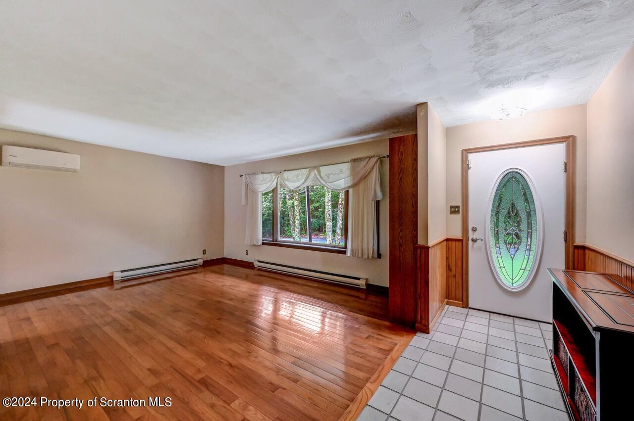 749 Elkview Drive Forest City, PA 18421 - Photo 7 of 73 a view of a room with wooden floor and windows