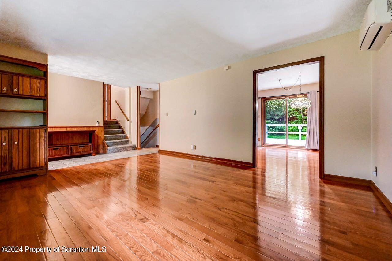 749 Elkview Drive Forest City, PA 18421 - Photo 9 of 73 a view of empty room with wooden floor and fan