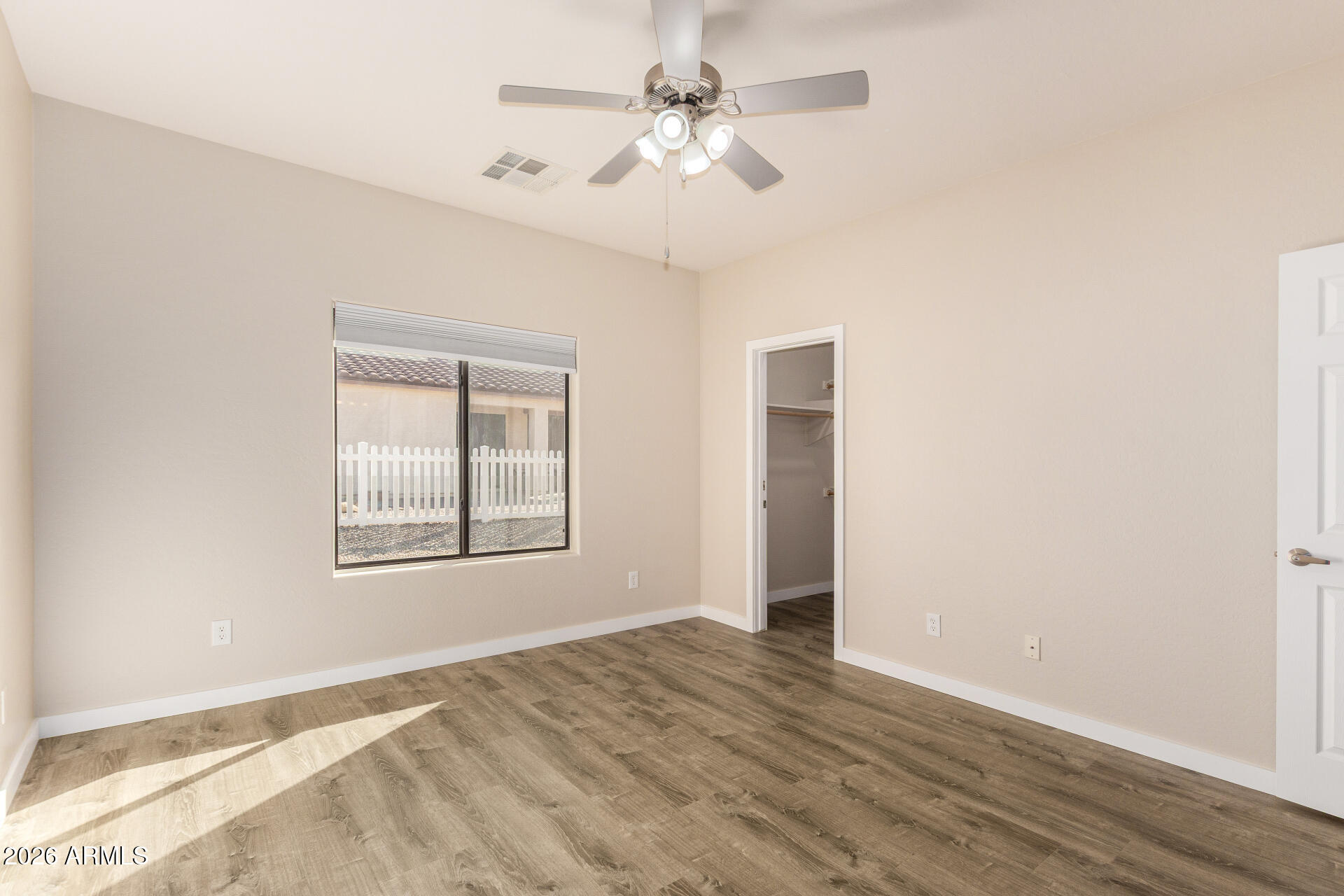 2101 South Meridian Road, Unit 204 Apache Junction, AZ 85120 - Photo 19 of 37 an empty room with chandelier fan and windows