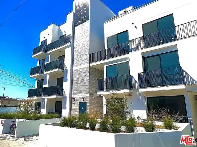 a bathroom with a granite countertop sink a toilet and a large mirror