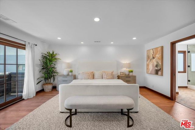 a living room with furniture a potted plant and a table