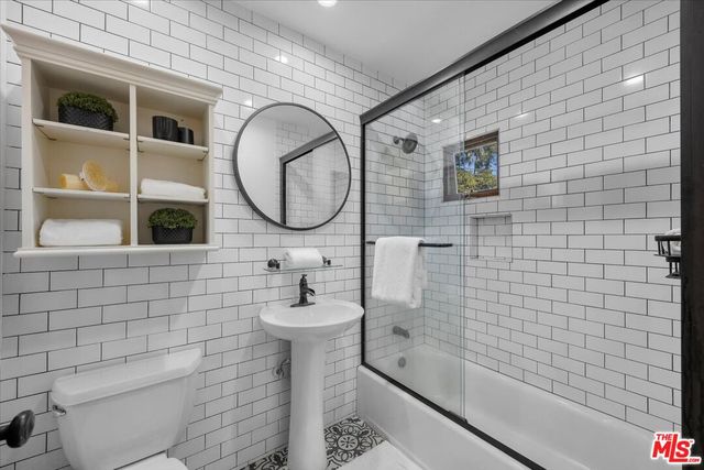 a bathroom with a toilet a sink and bathtub