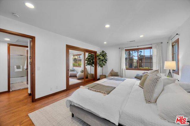 a bedroom with a large bed and a large window