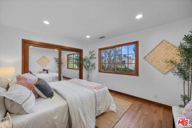 a bedroom with a large bed and a window