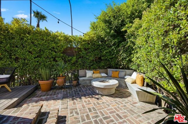 a view of a patio with table and chairs and potted plants