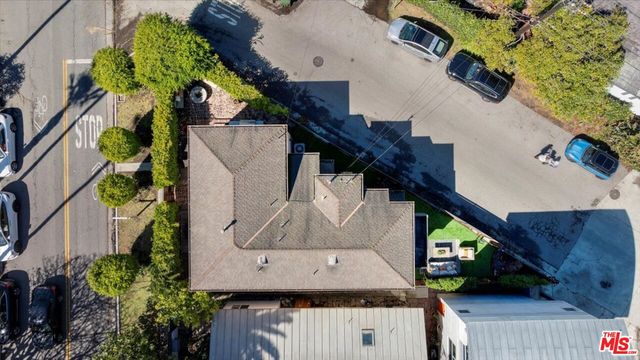 an aerial view of a house with a yard