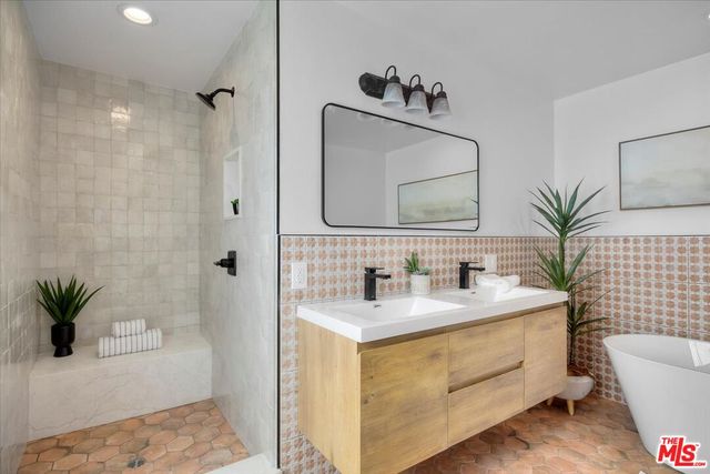 a bathroom with a granite countertop sink a toilet and mirror
