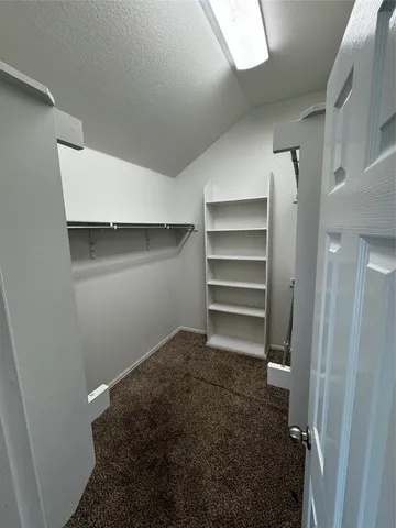 an empty room with a window and a ceiling fan