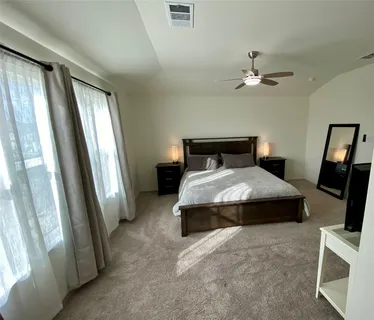 a bedroom with a bed and a large mirror