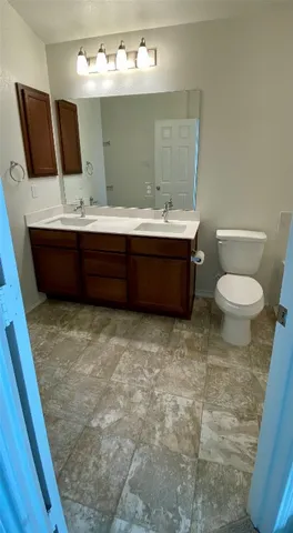 a bathroom with a sink a toilet and mirror