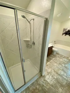 a bathroom with a glass shower door