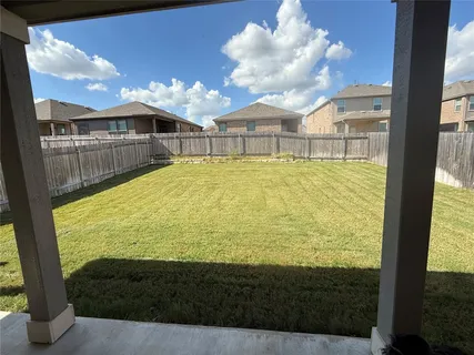 a view of a house with pool and chairs