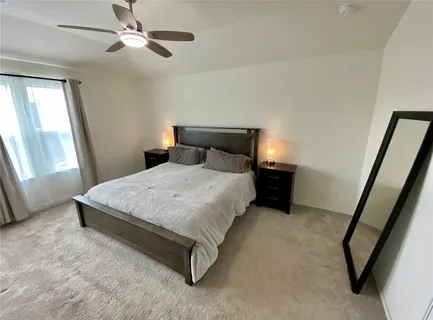 a bed sitting in a bedroom next to a window