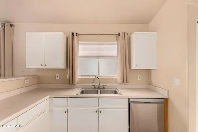 an empty room with a window and ceiling fan