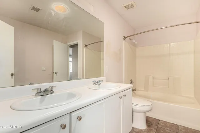 a white bath tub sitting next to a white sink