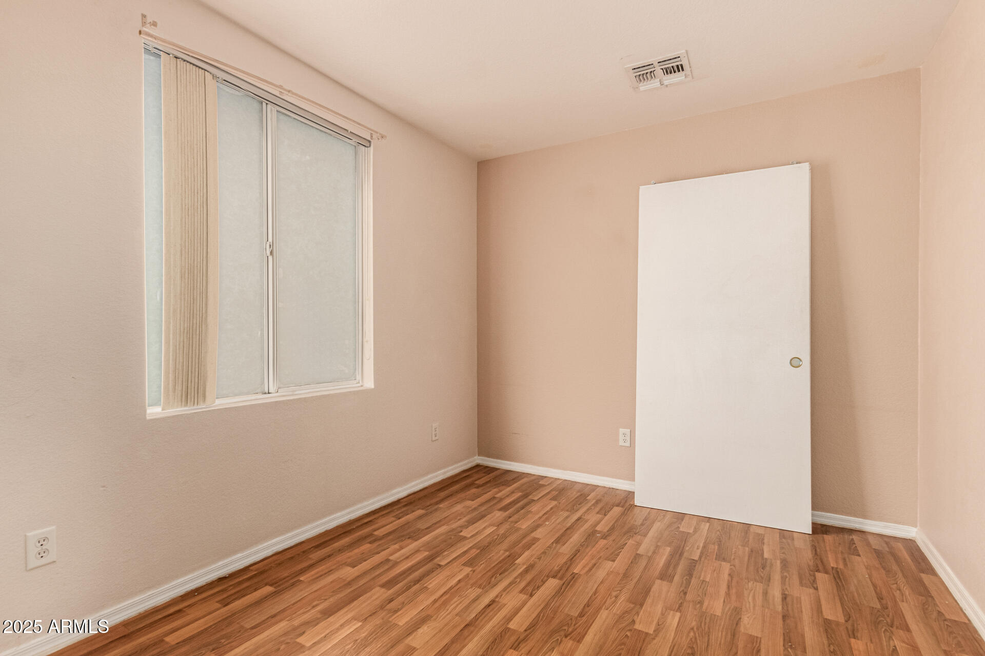2279 West 20th Avenue Apache Junction, AZ 85120 - Photo 20 of 28 a view of an empty room with wooden floor