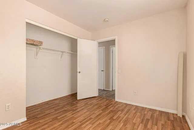 a view of a room with wooden floor and a window