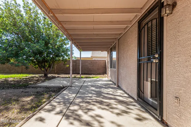 a backyard of a house with shaded area