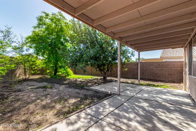 a view of a backyard with large trees