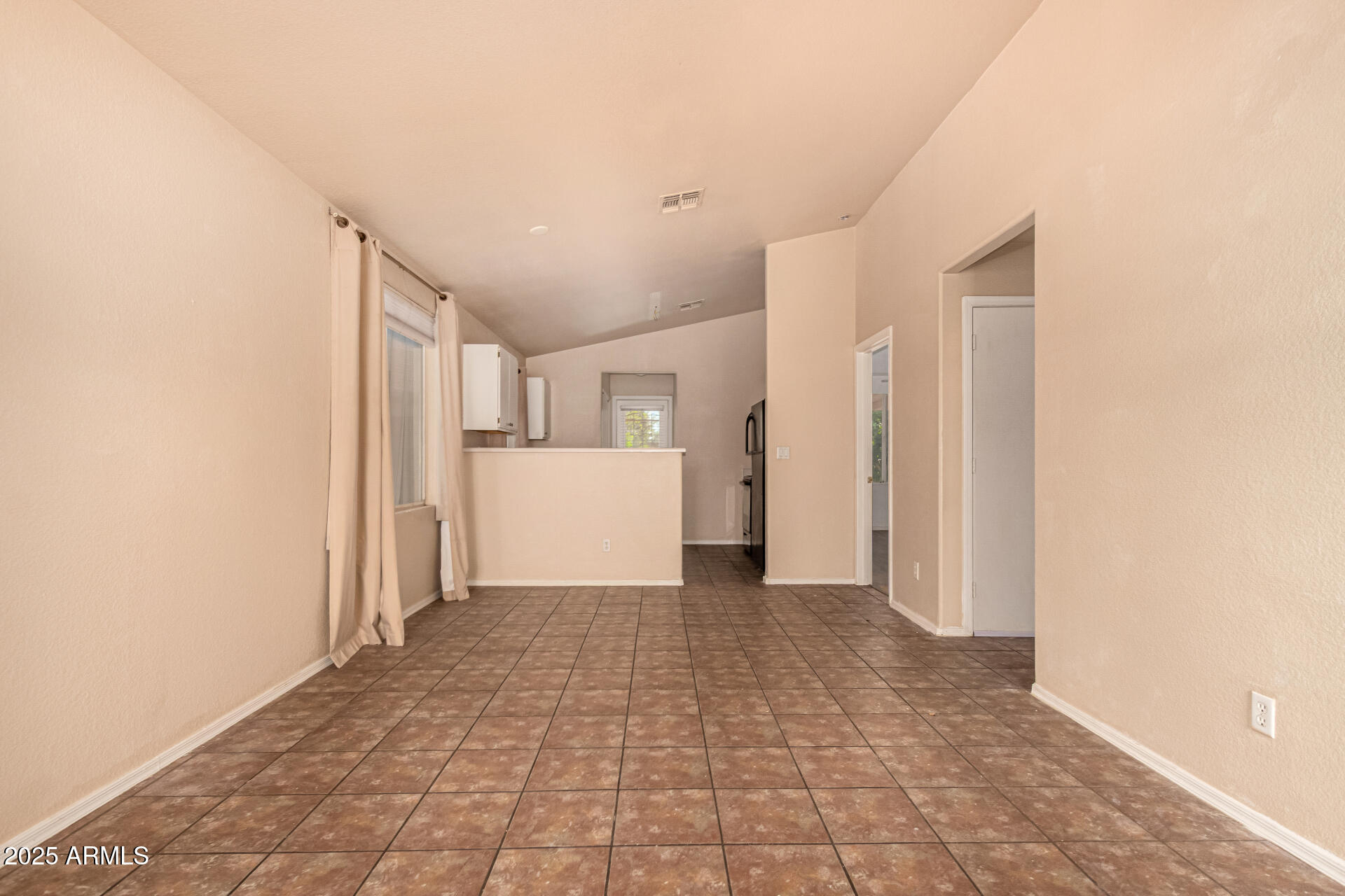 2279 West 20th Avenue Apache Junction, AZ 85120 - Photo 10 of 28 a view of a kitchen with a refrigerator and a sink
