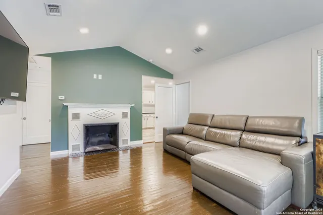 a living room with furniture and a fireplace