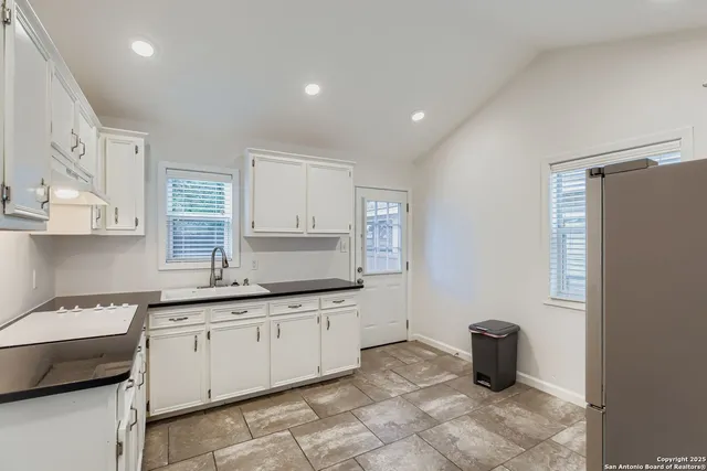 a kitchen with a sink cabinets and window
