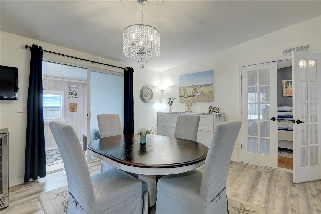 809 Lychee Drive Barefoot Bay, FL 32976 - Photo 11 of 36 a view of a dining room with furniture and wooden floor