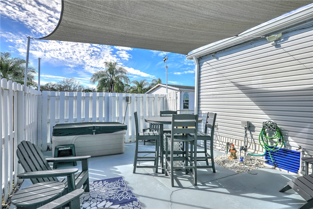 809 Lychee Drive Barefoot Bay, FL 32976 - Photo 25 of 36 a view of a patio with a table and chairs