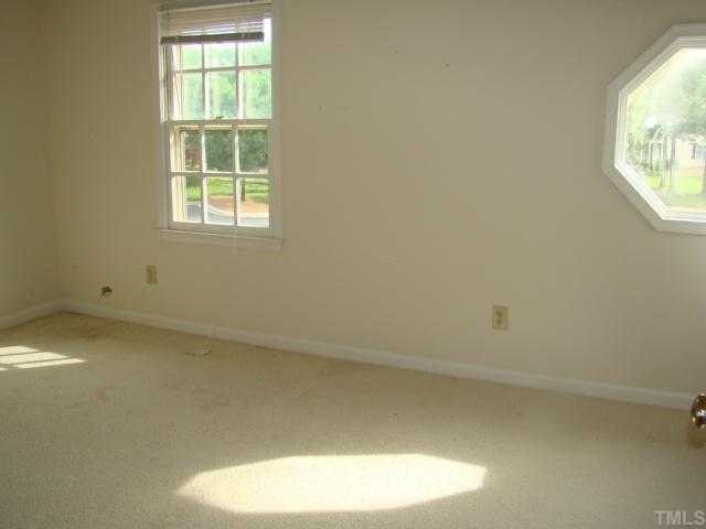 2933 Faversham Place Raleigh, NC 27604 - Photo 4 of 9 an empty room with a window